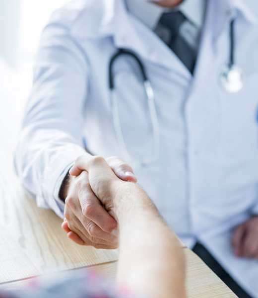 Doctor greeting a patient with a handshake