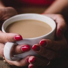 Hands holding a warm cup of tea